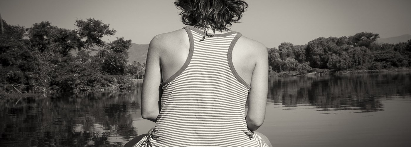 woman-relaxing-on-the-prow-of-a-boat-while-slowly-cruising
