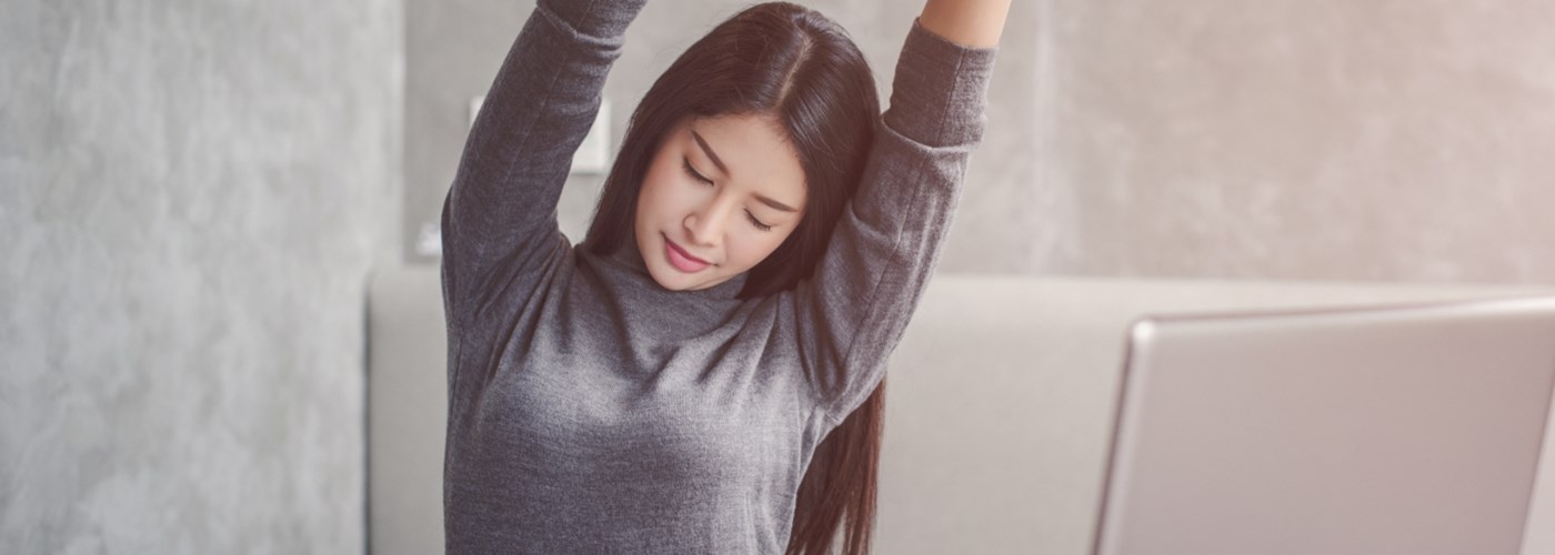 businesswoman stretching at her desk
