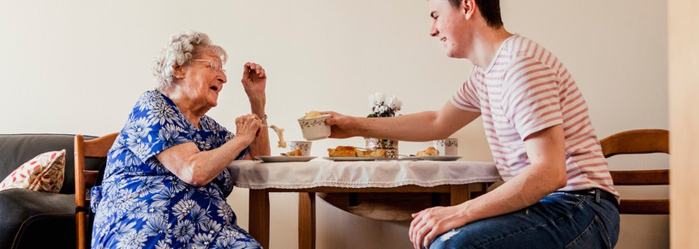 Young employee visiting his grandma who he cares for