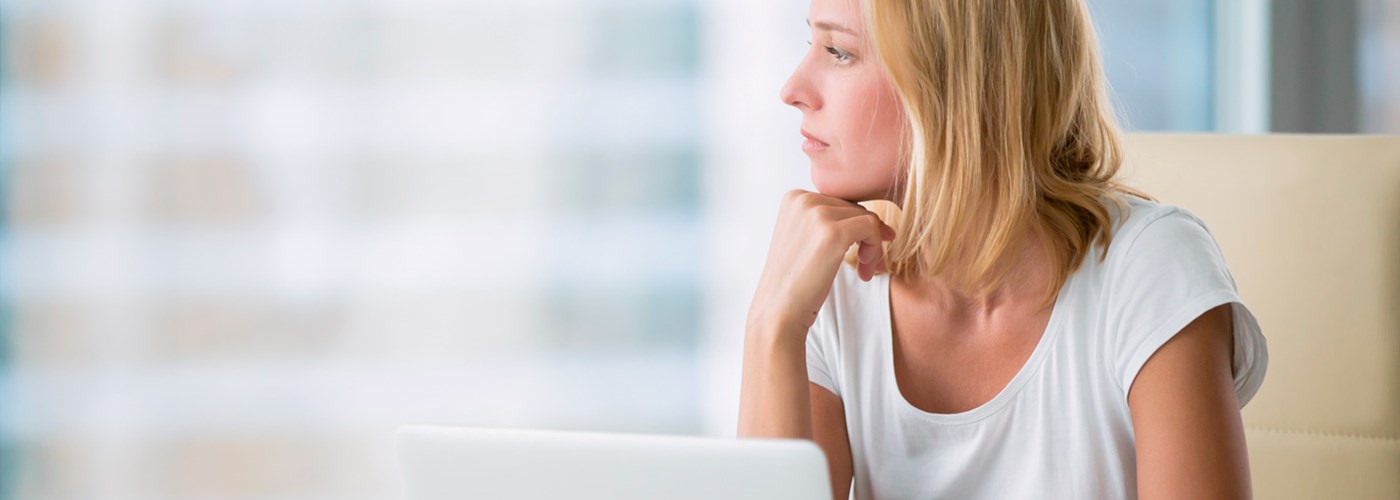Distraught employee looking through the window at work