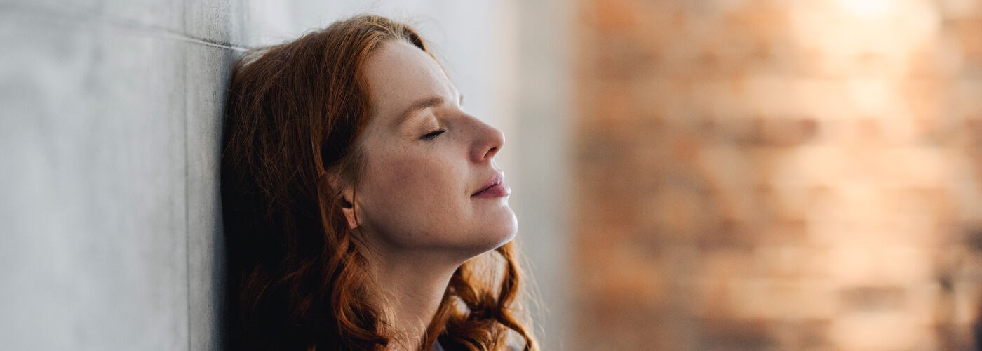 A lady leaning agaist the wall in relief