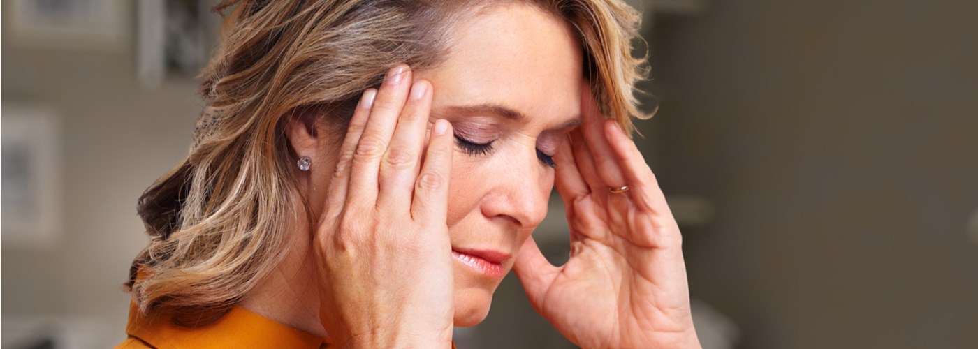 Woman struggling with migraine symptoms