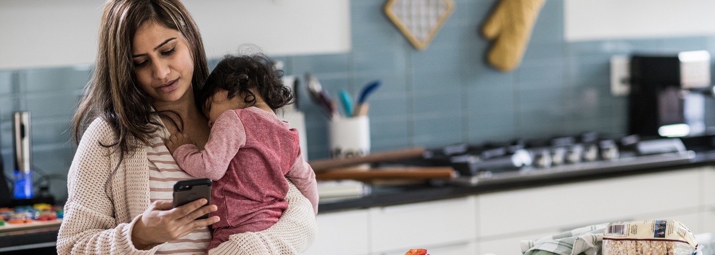 Mother and a toddler with a flue in the kitchen