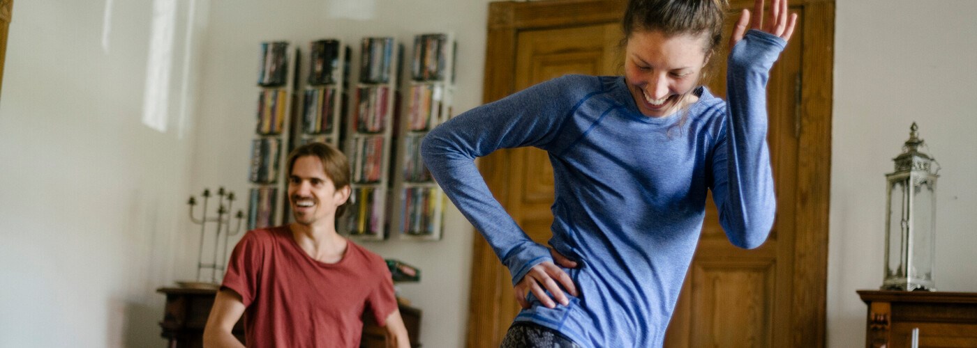 Couple working out, burning calories at home