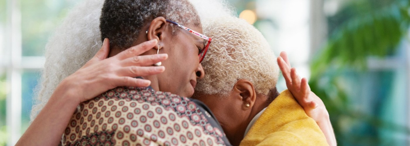 Three women are embracing, supporting each other