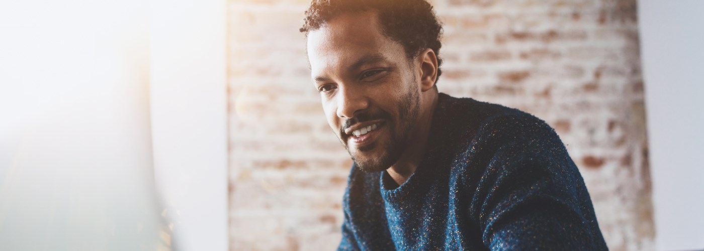 Man accessing an online GP service from home
