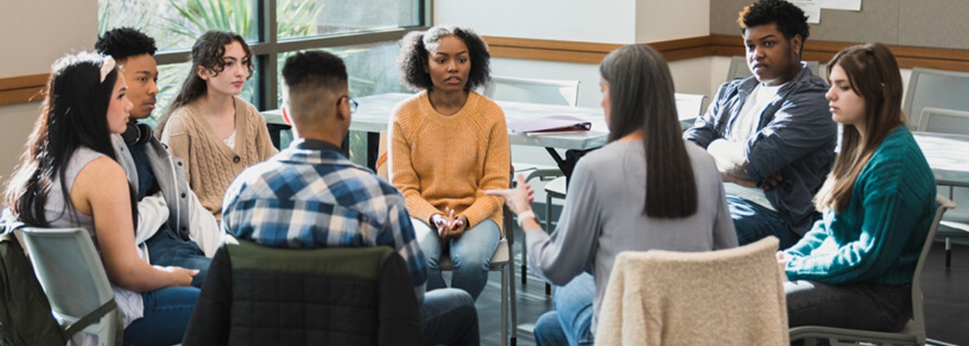A group of students sitting in a circle discussing an issue