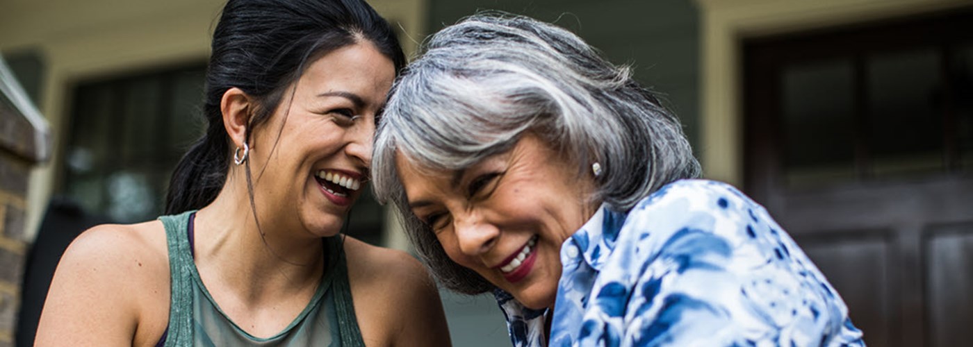 A woman and her daughter sat on their porch laughing 
