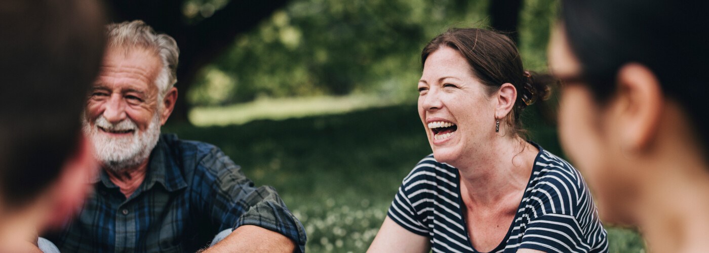 woman laughing in the park with her friends