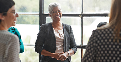 A businesswoman smiling in a meeting