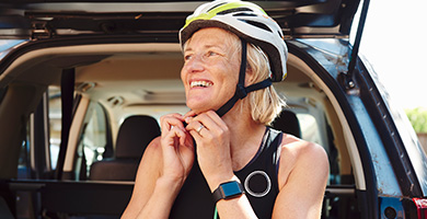 Lady putting on a safety helmet